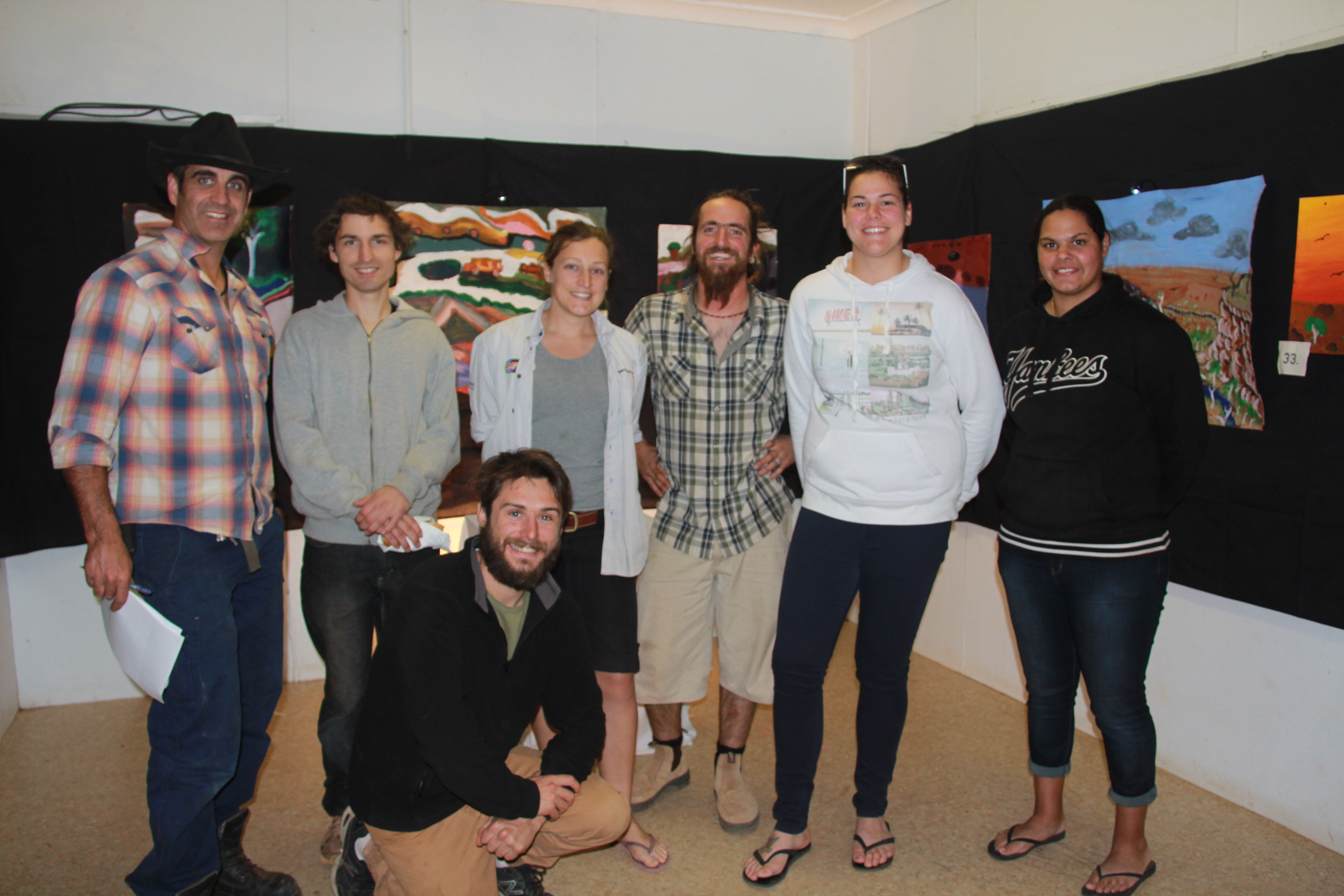 Exhibition Visitors. From to left to right: Damien Thornber, Carlo McAbee, Emily Minchin, Leo Ollivier, Ebony Humble, Larissa Bennell & Josh McHale (at front) - The Desert Feet Tour and Ngurra Kujunka mob enjoying the vibe at the exhibition